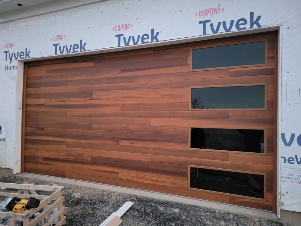 Modern wooden garage door with horizontal windows installed by Access Door Systems in Uniontown, PA.