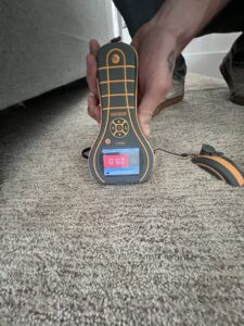 A moisture meter showing a reading of 25.0 on carpet, indicating water damage assessment by Utah Home Restoration in Springville, UT