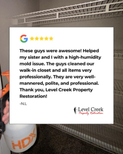 A technician performing mold remediation in a walk-in closet, addressing a high-humidity issue by Level Creek Property Restoration in Buford, GA.