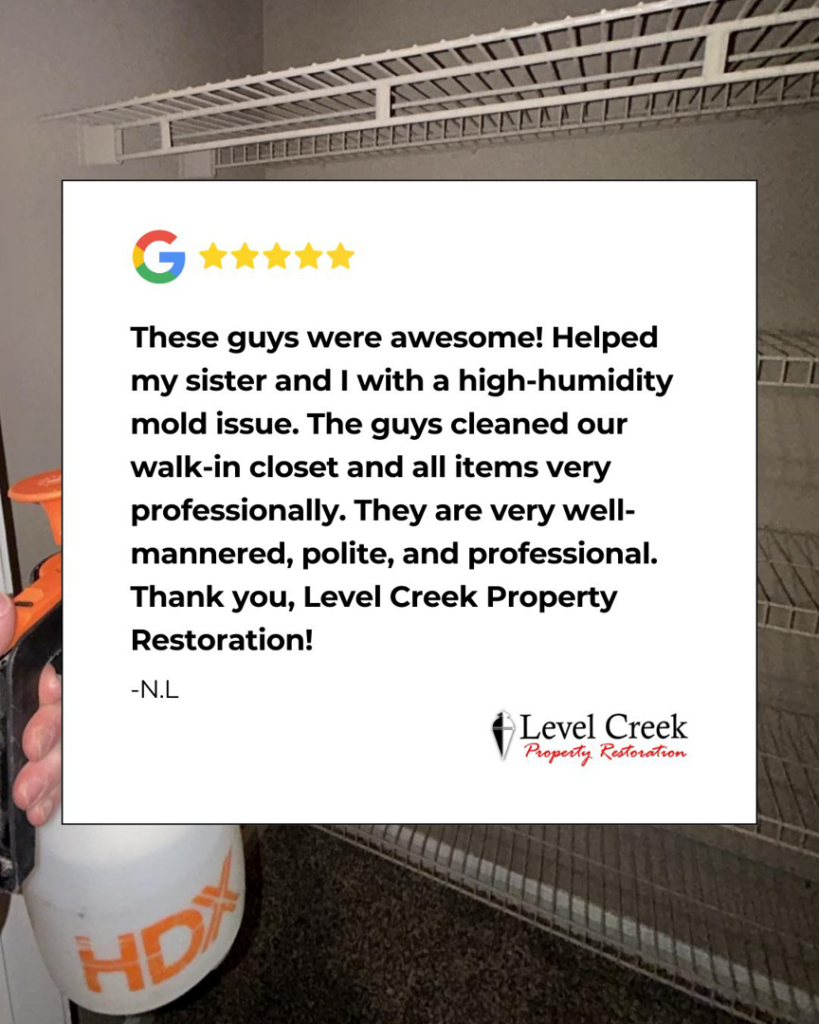 A technician performing mold remediation in a walk-in closet, addressing a high-humidity issue by Level Creek Property Restoration in Buford, GA.