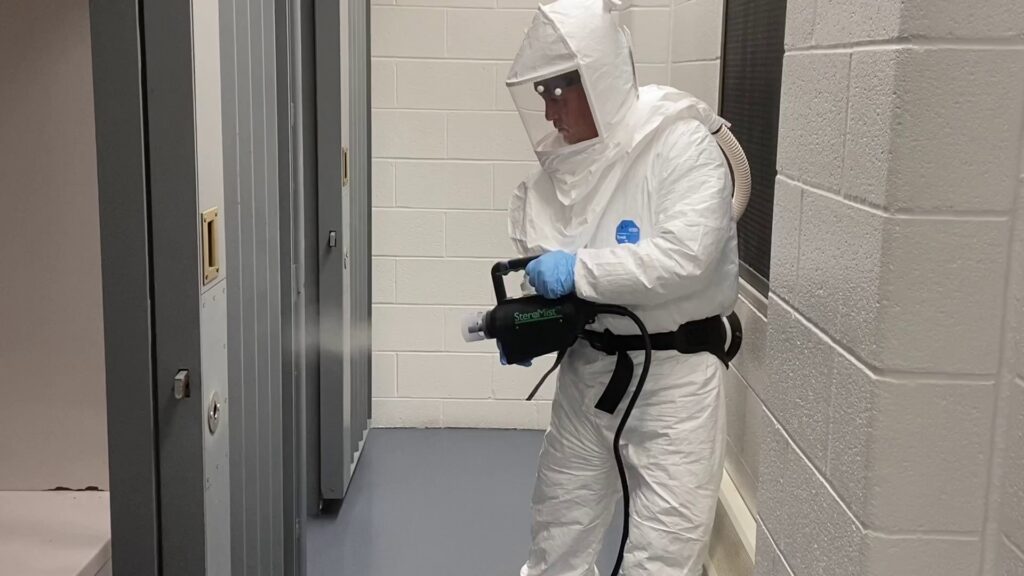 A specialist in a hazmat suit performing mold remediation after water damage for JP Maguire Associates in Waterbury, CT.