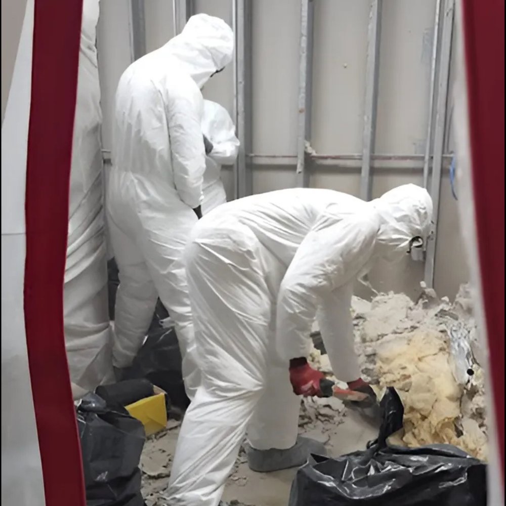 Workers in hazmat suits removing mold-damaged wall materials during remediation by Superior Contract Cleaning in Lafayette, LA.