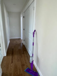 A mop leaning against a clean hallway wall, indicating professional house cleaning services by Straight Up Cleaning in South Portland, ME.