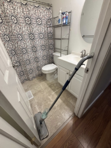 A mop on a tiled bathroom floor, ready for cleaning by Nova's Home Cleaning Services in Roanoke, VA.