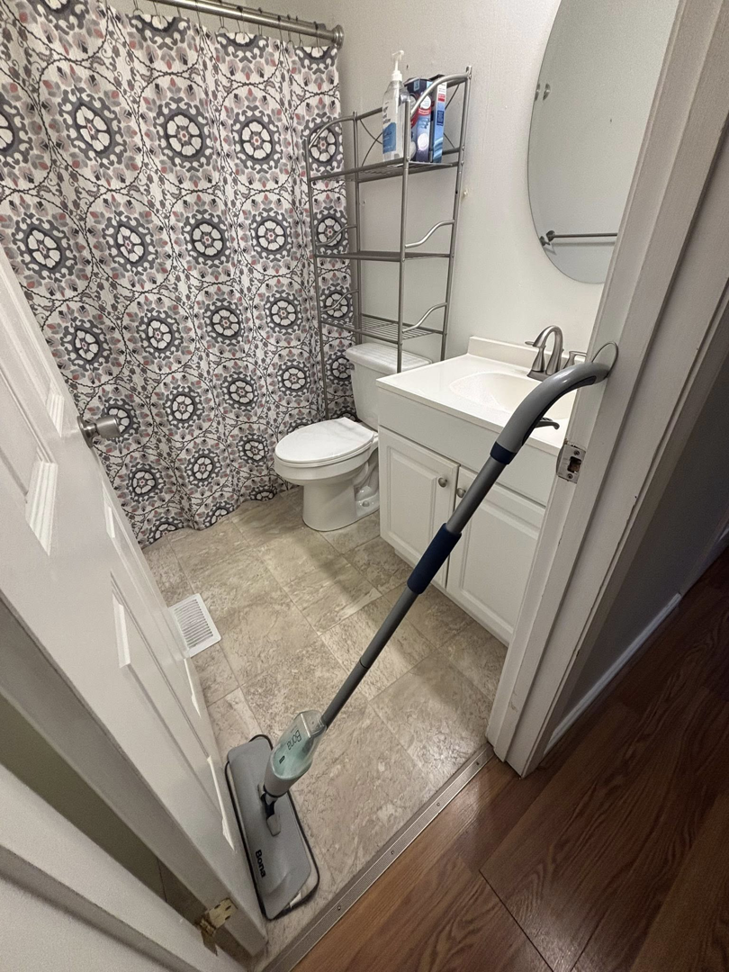 A mop on a tiled bathroom floor, ready for cleaning by Nova's Home Cleaning Services in Roanoke, VA.