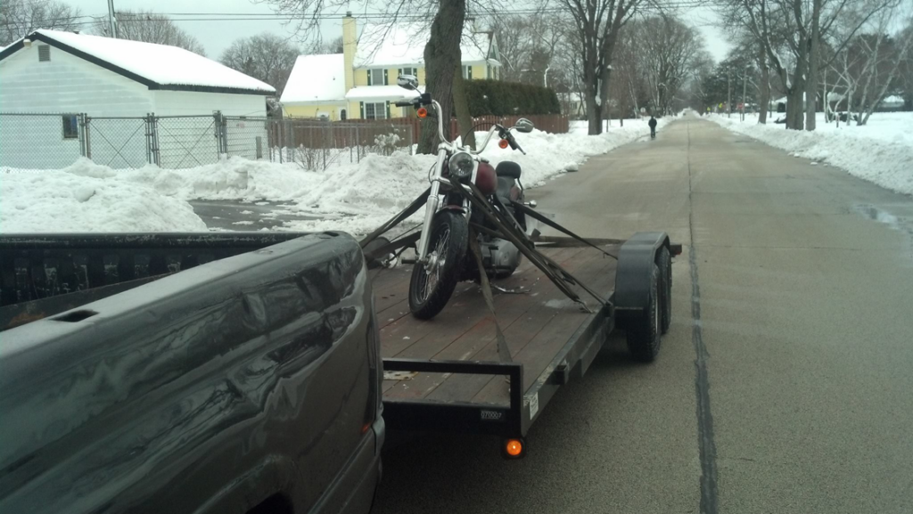 A motorcycle secured on a flatbed trailer for towing by Jr & Sr towing and recovery in Waukegan, IL.