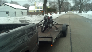 A motorcycle secured on a flatbed trailer for towing by Jr & Sr towing and recovery in Waukegan, IL.
