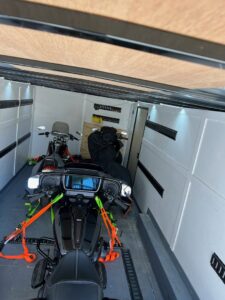 Two motorcycles securely strapped inside an enclosed trailer from B'ham Trailer Rentals in Alabaster, AL.