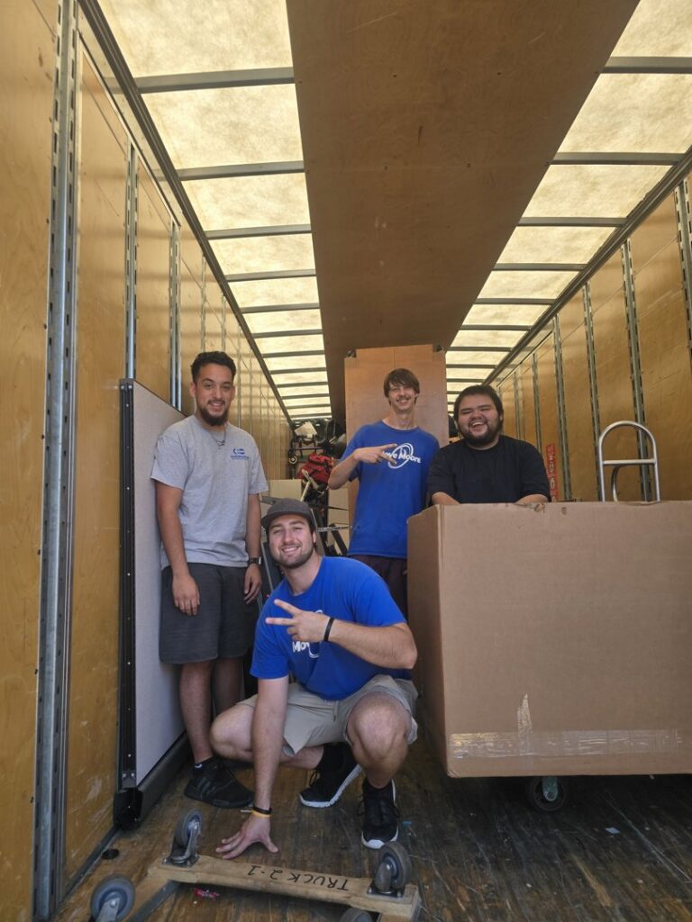 Move Moore team members inside a moving truck with boxes and equipment in Grand Rapids, MI.