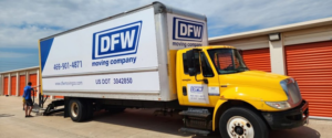 A mover from DFW Moving Company, LLC preparing a moving truck at a storage facility in Plano, TX.