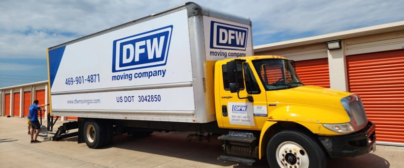 A mover from DFW Moving Company, LLC preparing a moving truck at a storage facility in Plano, TX.