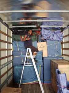 A mover giving a thumbs up inside a fully packed S&P Network's Marathon Moving Solutions truck in Mechanicsburg, PA.