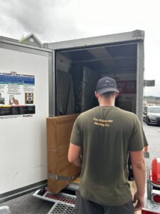 A mover from The Knoxville Moving Co. loading a box into a U-Box moving container in Knoxville, TN.