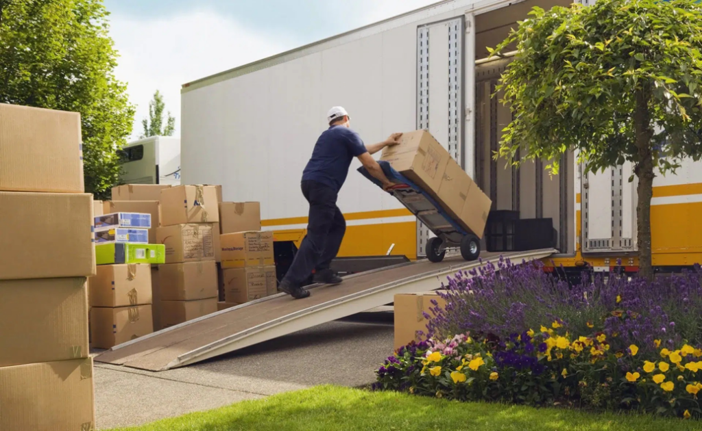 A mover pushing a large box up a ramp into a moving truck for Central Movers, Inc. in Annapolis, MD.