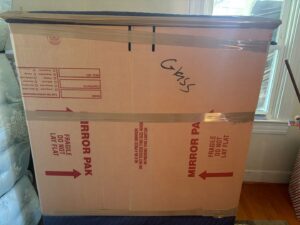 A mover loading wrapped furniture onto the lift gate of a moving truck for Household Goods Moving and Storage in Rockville, MD