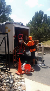 A professional mover loading items into a truck with a hand truck for A Nice Move LLC in Albuquerque, NM.