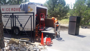 A professional mover using a hand truck to move a refrigerator for A Nice Move LLC in Albuquerque, NM.
