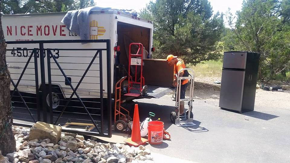 A professional mover using a hand truck to move a refrigerator for A Nice Move LLC in Albuquerque, NM.