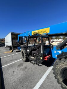 A mover from The Knoxville Moving Co. operating a forklift to load items onto a moving truck in Knoxville, TN.