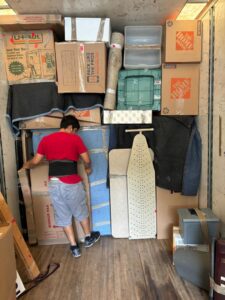 A mover carefully packing items inside a moving truck for Household Goods Moving and Storage in Rockville, MD