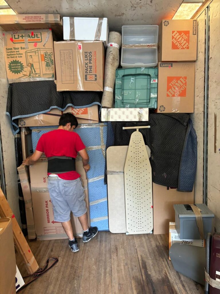 A mover carefully packing items inside a moving truck for Household Goods Moving and Storage in Rockville, MD