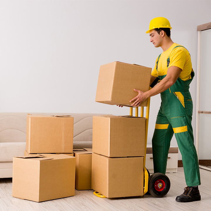A mover using a hand truck to move boxes in a home for Delivery on Demand in Scottsdale, AZ
