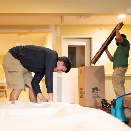 Two Mastodon Moving LLC movers carefully handling a large item during a move in Westborough, MA.