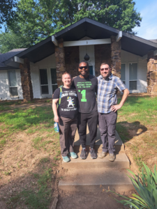 Three movers standing in front of a house for Coach Carter Fitness at BLB Training Next level in Fayetteville, AR