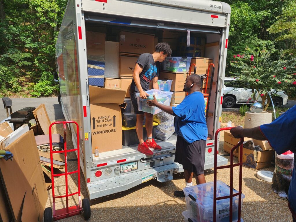 Ron's Moving team loading boxes and bins onto a moving truck in Little Rock, AR.