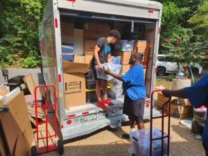 Ron's Moving team loading boxes and bins onto a moving truck in Little Rock, AR.