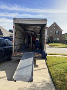 Professional movers loading furniture into a moving truck with a ramp for allpromovingservice in San Antonio, TX.