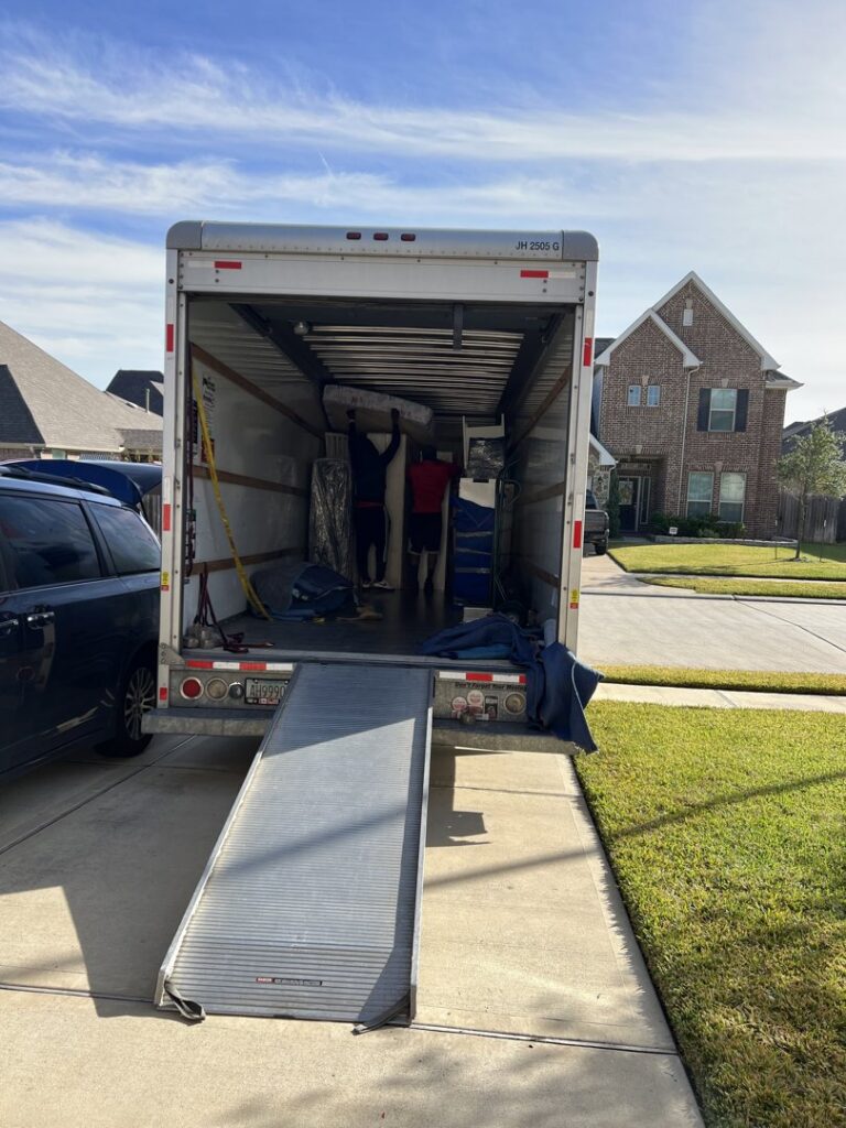 Professional movers loading furniture into a moving truck with a ramp for allpromovingservice in San Antonio, TX.
