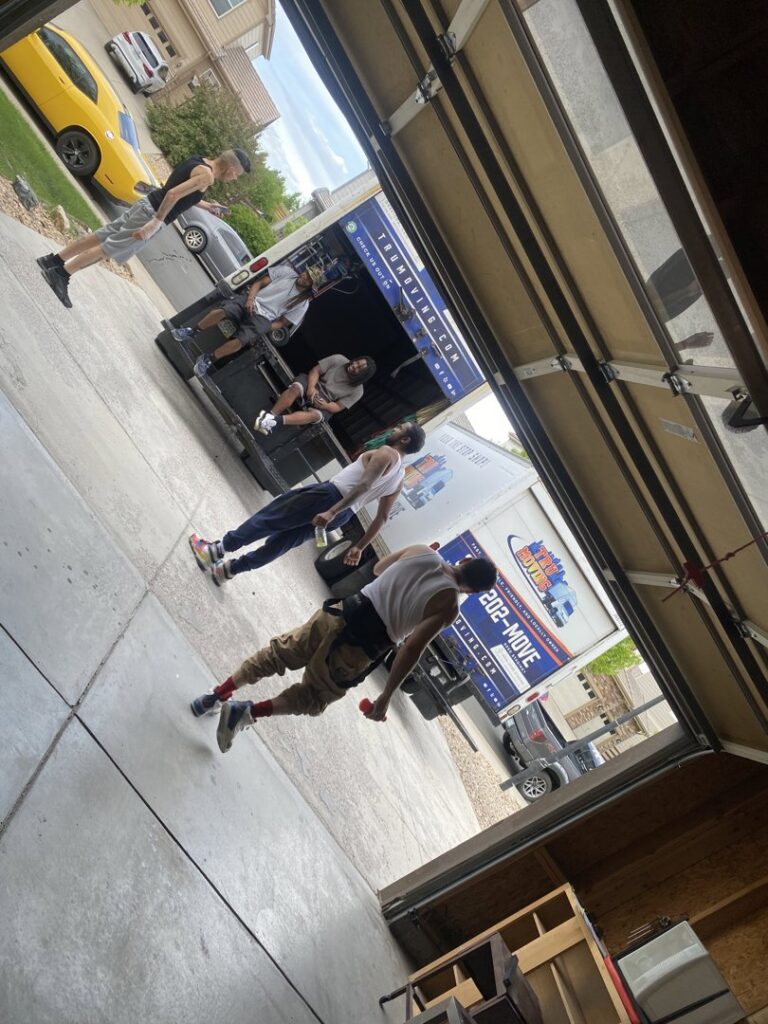 TruMoving movers actively loading items into a moving truck during a job in Lakewood, CO.