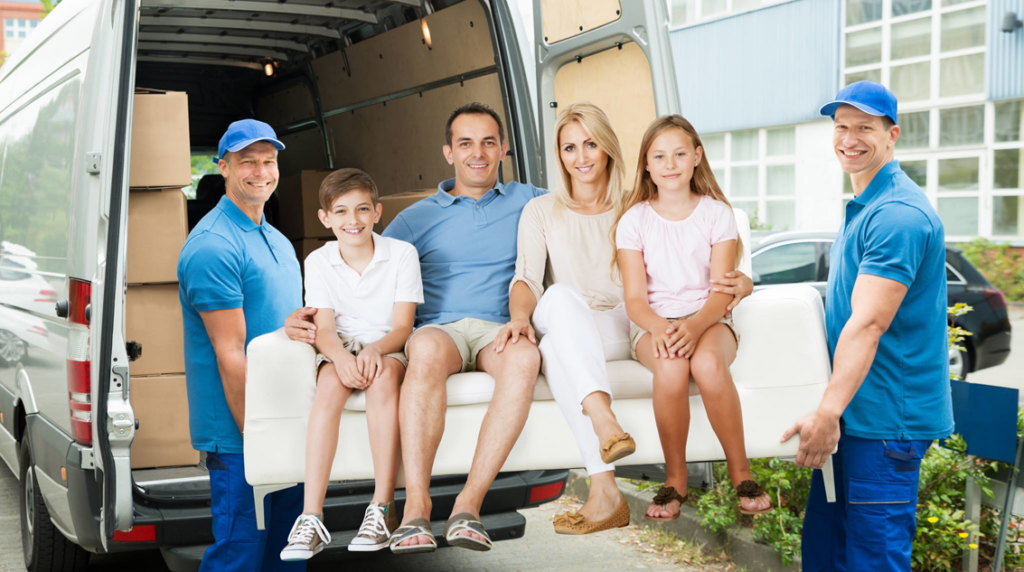 Professional movers loading a sofa with a family during a home relocation service by Comfort Home Movers, LLC in Plano, TX.