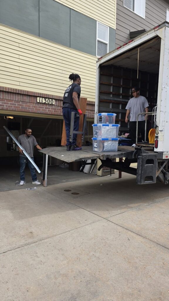 TruMoving movers loading boxes and furniture onto a moving truck using a ramp in Lakewood, CO.