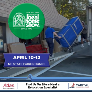 Professional movers loading a large, blue-wrapped item onto a moving truck for Capital Relocation Group in Raleigh, NC.