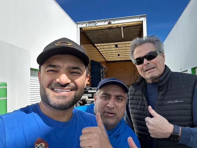 Three men, including a Let's Get Moving team member, giving thumbs up in front of a moving truck in Saint Petersburg, FL.