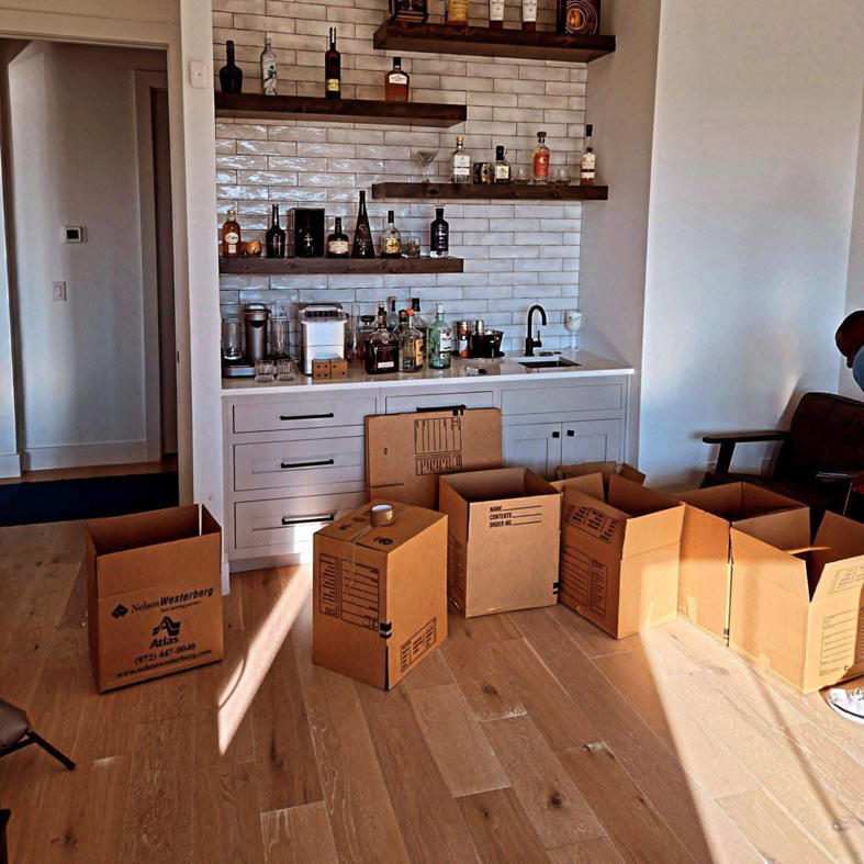 Cardboard moving boxes on the floor in a home, ready for packing or unpacking by Comfort Moving & Storage in San Antonio, TX.