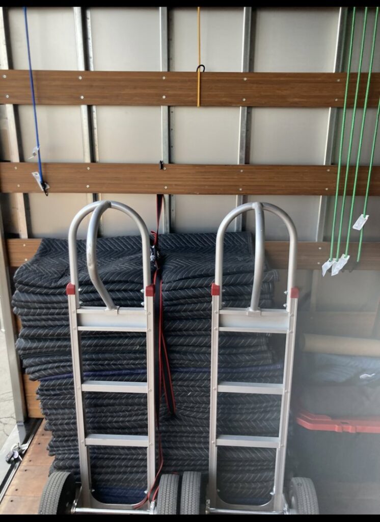 Moving equipment, including hand trucks and blankets, inside a truck for Fatboy Slims Moving Company in Colorado Springs, CO.