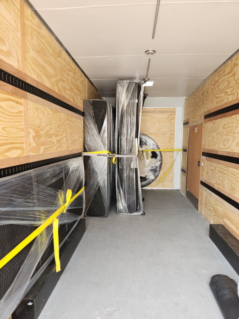 An Ang Moving Co trailer packed with secured and wrapped furniture, ready for transport in Dallas, TX