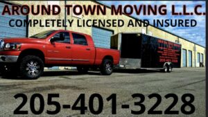 A red pickup truck towing a branded moving trailer for Around Town Moving LLC Alabama in Alabaster, AL.