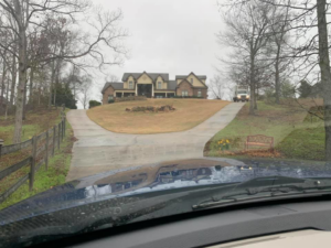 A moving truck parked at a large residential house, ready for a job by Around Town Moving LLC Alabama in Alabaster, AL.