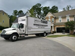 A Miracle Movers of Charleston, SC truck parked at a residential home with a ramp, ready for a move in Summerville, SC.