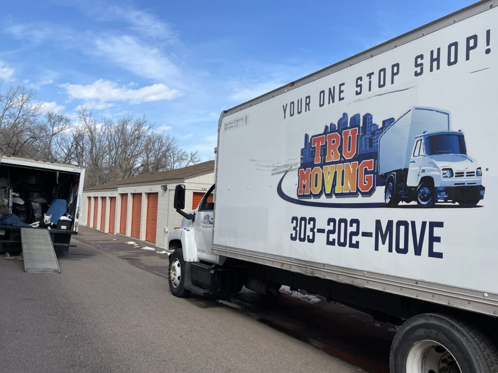 A TruMoving truck parked at a storage facility with a ramp, ready for loading or unloading in Lakewood, CO.