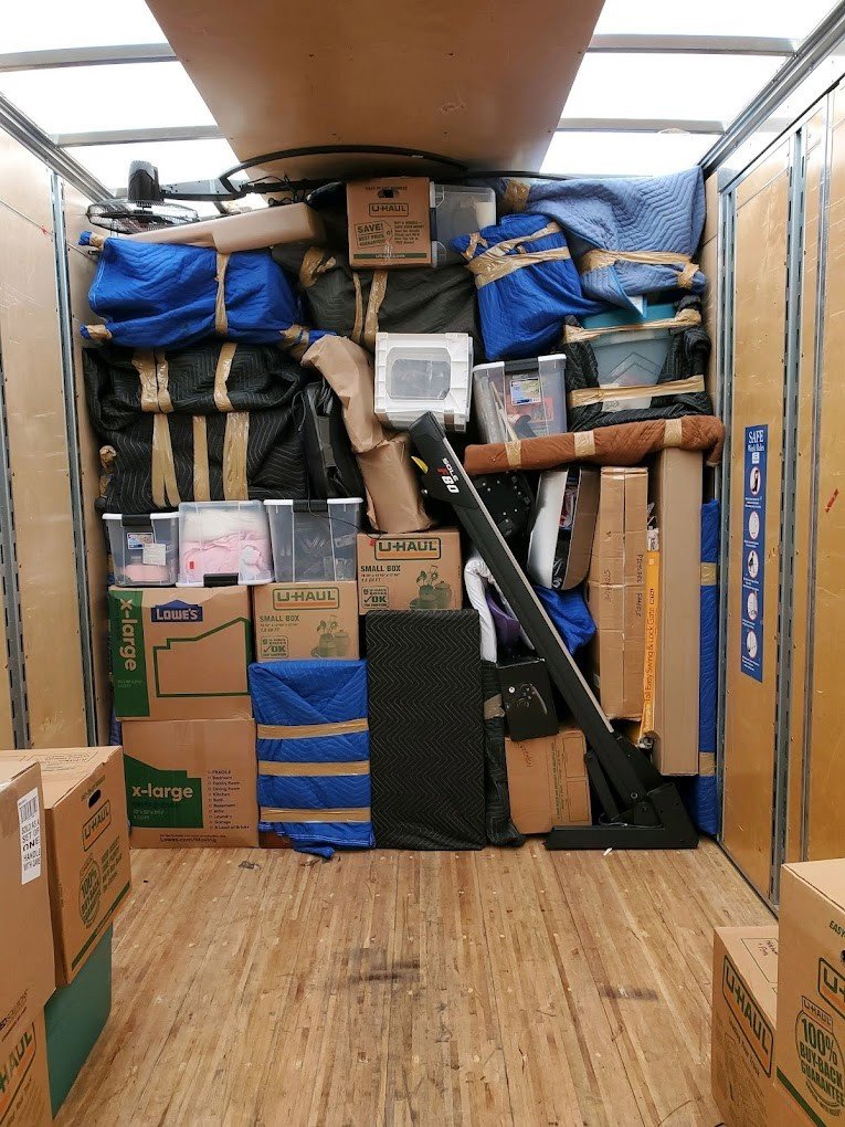 A moving truck fully packed with household items and furniture pads by Move Moore in Grand Rapids, MI.