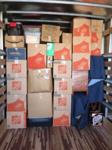 The interior of a moving truck meticulously packed with various boxes and protective moving blankets by Academy Movers in Gilbert, AZ.