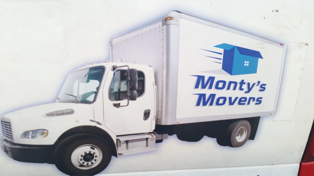 A moving truck partially loaded with furniture and boxes, ready for transport by Monty's Movers in Fairfax, VA.