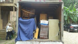 The back of a moving truck fully loaded with furniture and boxes by Emanuel Movers, Inc. in Houston, TX