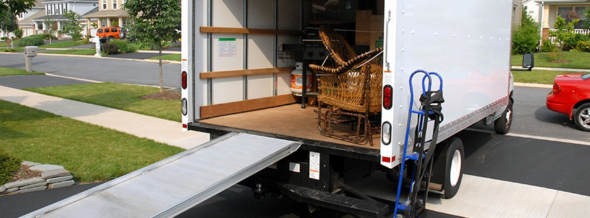 A moving truck with its ramp down, partially loaded with household items, for Central Movers, Inc. in Annapolis, MD.