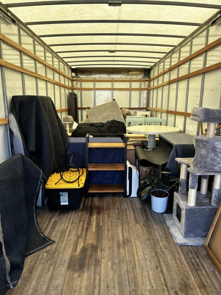 Interior of a moving truck fully loaded with furniture, boxes, and moving blankets by The Knoxville Moving Co. in Knoxville, TN.